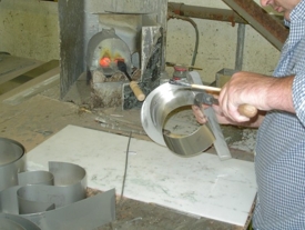 Skilled craftsman making built up metal lettering